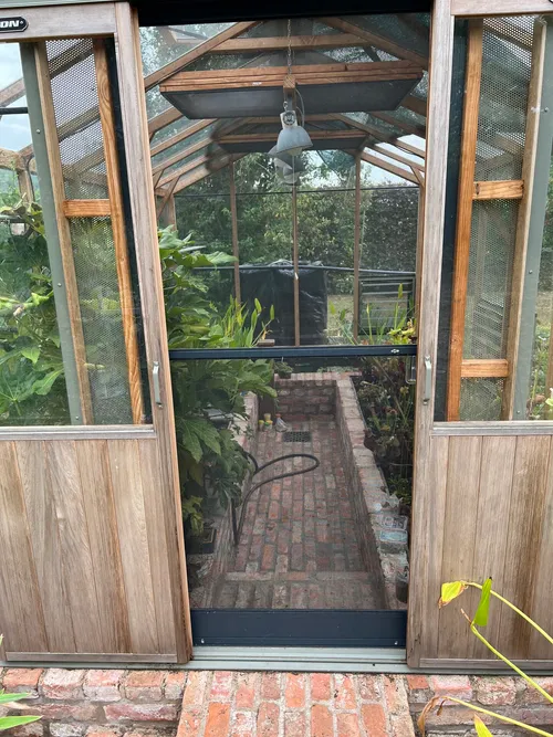 62. A bit later on in the day, we visited Chris"s new wooden greenhouse - imported from the UK and entirely for his personal collection, this was his latest hobby project