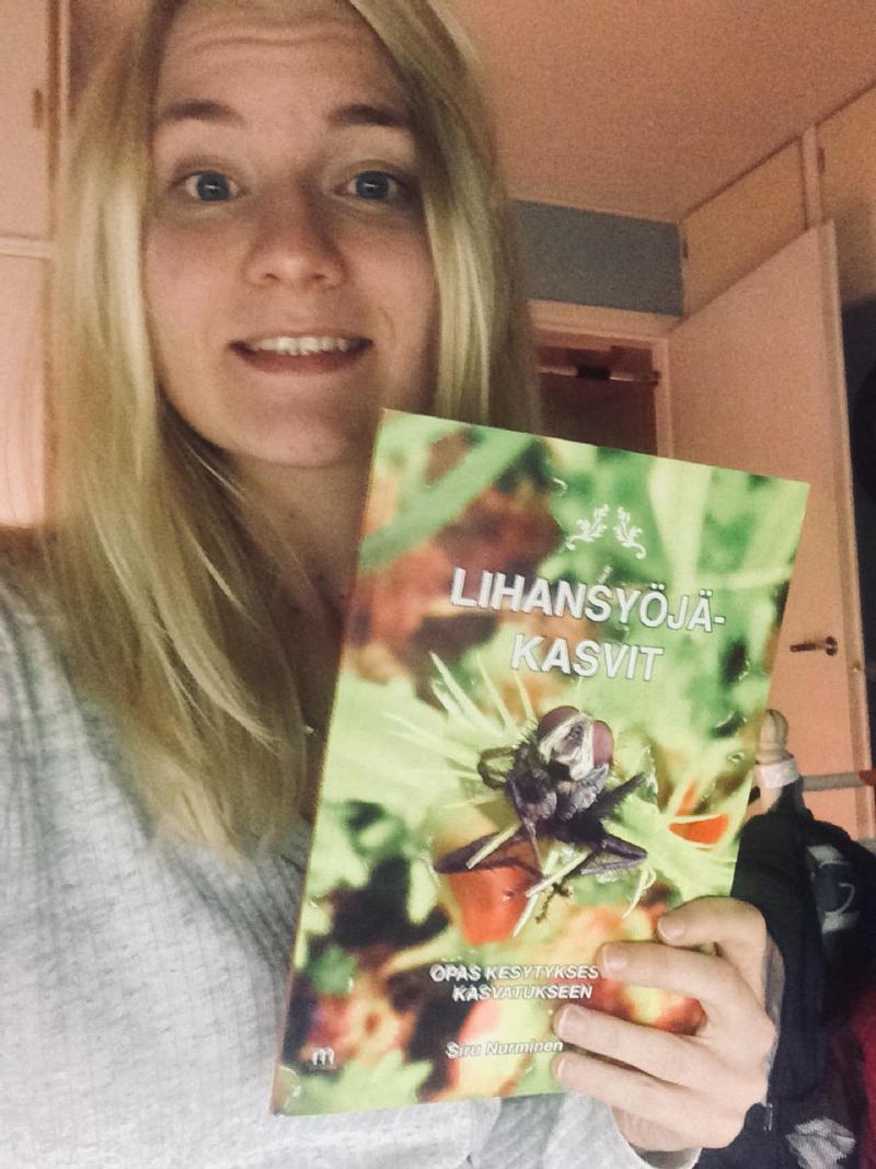 Siru and her book. 'Lihansyöjäkasvit' is 'carnivorous plants' in Finnish.